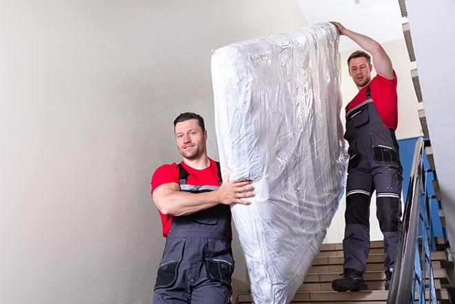 tackling the task of transporting a box spring out of a building in Hazelton ID